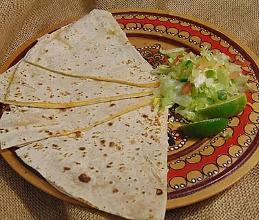 A quesadilla plate with guacamole