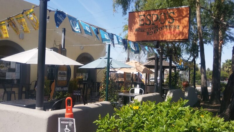 The Espo's patio with flags and the wooden sign overhead