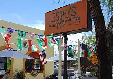 The Espo's road sign with papel picado flags strung across the patio